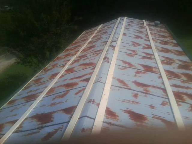 Rusted metal roof panels with new wood purlins before replacement — Storm Damage Roof Repair in Peralta by Roofing Brothers